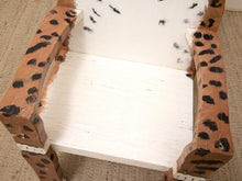 Load image into Gallery viewer, A handmade wooden chair with a white-painted seat and backrest, and leopard-print painted armrests and legs, resting on a beige carpet.