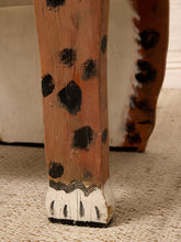 Load image into Gallery viewer, Close-up of a rustic wooden table leg painted in a dalmatian spot pattern with a white paw-print base, resting on a textured beige rug.