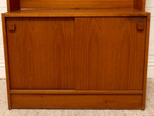 Load image into Gallery viewer, A mid-century modern wooden cabinet with two sliding doors, crafted from warm reddish-brown wood with a visible grain pattern.