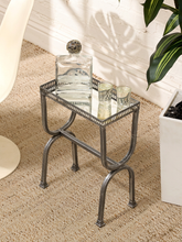 Load image into Gallery viewer, Vintage chrome and glass side table with pierced gallery-style border, reflective top, and curved Hollywood Regency legs.