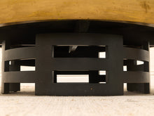 Load image into Gallery viewer, Close-up of the base of a round wooden table or stool, showing a black slatted circular support frame on a light beige carpet.