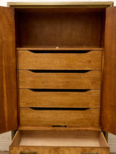 Load image into Gallery viewer, A vintage wooden chest of drawers with two open doors and four drawers in the center, plus a fifth drawer pulled out at the bottom. The cabinet features a warm medium-brown wood finish with a lighter natural wood interior.