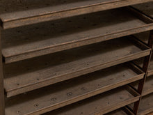 Load image into Gallery viewer, Close-up of dark brown wooden shelving with multiple tiers and visible screw holes, photographed in a dim indoor setting.