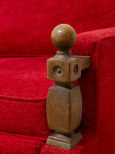 Load image into Gallery viewer, A decorative brown stone or concrete stair rail finial with a spherical top and square block details, shown resting on a bright red carpeted staircase.