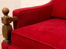 Load image into Gallery viewer, Close-up of a red upholstered armchair with a textured bouclé fabric and a carved wooden armrest post.