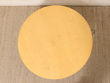 Load image into Gallery viewer, A round light wood table top or stool pad shown from above on a woven beige rug.