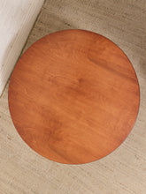 Load image into Gallery viewer, A round wooden table top with a warm reddish-brown finish and visible wood grain, photographed from above on a textured beige rug.