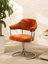 Load image into Gallery viewer, 1970s burnt orange velvet swivel chairswith curved back and sculptural chrome loop base