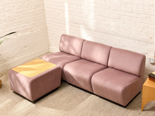 Load image into Gallery viewer, John Mascheroni Tappo modular sofa in dusty mauve upholstery with three low-profile seats and matching wood-top ottoman