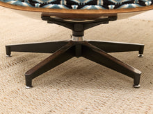 Load image into Gallery viewer, Close-up of a mid-century modern lounge chair base with a dark wood five-star pedestal and a patterned blue, black, and white seat cushion on a beige textured rug.