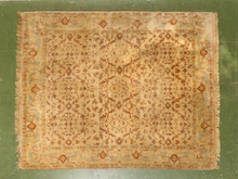Load image into Gallery viewer, Vintage hand-knotted silk Oushak-style area rug with warm ivory field, faded rust floral motifs, pale blue border, and softly aged patina.