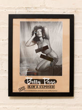 Load image into Gallery viewer, Framed Betty Page Raw and Exposed black-and-white pin-up art print with leopard-print draping and graphic censor bars