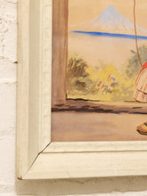 Load image into Gallery viewer, A close-up of a framed painting showing part of a landscape with a mountain, trees, and a figure in a striped garment, mounted on a white brick wall.