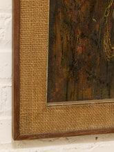 Load image into Gallery viewer, Close-up of a framed artwork showing a dark brown and black textured painting with a rustic wooden frame and tan burlap matting, mounted on a white brick wall.