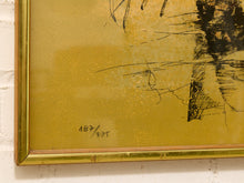 Load image into Gallery viewer, Close-up of a framed abstract artwork with a gold background, black sketch-like lines, and a gold frame against a white wall.