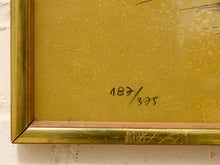 Load image into Gallery viewer, Close-up of a framed artwork corner with a gold-toned frame and a yellow-gold textured interior surface featuring handwritten markings and a faint circular logo.