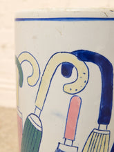 Load image into Gallery viewer, Close-up of a white ceramic mug featuring a hand-painted, whimsical illustration of umbrellas in blue, green, pink, and cream with blue outlines.