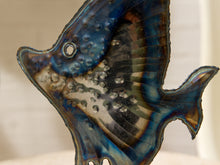 Load image into Gallery viewer, A close-up of a decorative wall hanging shaped like a tropical fish, featuring a glossy blue, black, and iridescent brown finish with textured bubble-like details.
