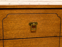 Load image into Gallery viewer, Close-up of a warm medium-brown wooden dresser drawer featuring a decorative brass pull handle.