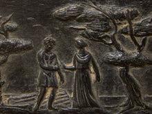 Load image into Gallery viewer, Close-up of a dark bronze or black bas-relief sculpture depicting two figures standing in a landscape with trees.