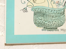 Load image into Gallery viewer, A close-up of a framed art print featuring a whimsical hand-drawn illustration of a patterned teal pot with flowers and the signature 'Wildi' in the lower right corner.