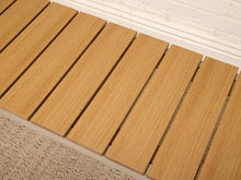 Load image into Gallery viewer, Light brown wooden deck slats arranged diagonally on a patio surface next to a white brick wall and textured beige rug.