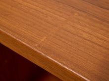Load image into Gallery viewer, Close-up of a warm medium-brown wooden tabletop surface showing the wood grain and a visible seam or joint line.