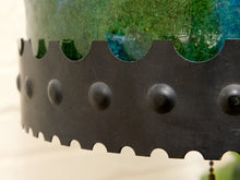 Load image into Gallery viewer, Close-up of a decorative metal band with a scalloped edge and raised circular studs, shown against a blurred green and blue textured background.