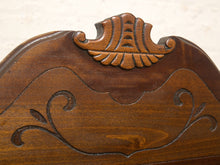 Load image into Gallery viewer, Close-up of a carved wooden headboard with a shell-shaped crest and scrollwork details in medium-to-dark brown wood.