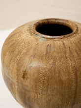 Load image into Gallery viewer, A close-up of a round ceramic vase with a textured, speckled brown and beige glaze and a dark opening.
