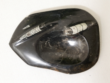 Load image into Gallery viewer, A polished black obsidian stone dish with a carved white and gray banded stone inlay, photographed on a textured off-white background.