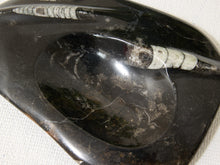 Load image into Gallery viewer, A polished black stone dish with a white and gray banded pattern running horizontally across the top, photographed close-up on a white textured fabric background.