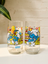 Load image into Gallery viewer, Pair of vintage clear Smurfs drinking glasses with colorful cartoon character illustrations