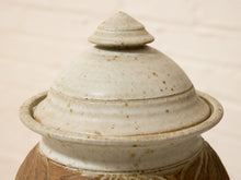 Load image into Gallery viewer, Close-up of a ceramic lidded container or jar with a rounded domed lid in a speckled off-white glaze, set against a light neutral background.