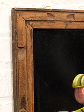Load image into Gallery viewer, Close-up of a rustic dark brown wooden picture frame with carved details, leaning against a white brick wall next to a black canvas showing part of a cartoon character.