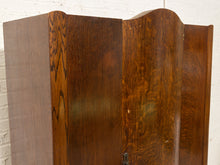 Load image into Gallery viewer, A close-up of a dark brown wooden cabinet or screen with a glossy, figured wood grain finish, set against a white brick wall background.