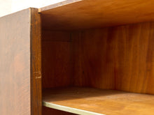 Load image into Gallery viewer, Close-up of the interior corner of a wooden cabinet or shelf unit, showing warm medium-brown wood grain on the back panel and shelf surfaces.