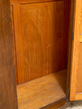 Load image into Gallery viewer, Close-up of the interior of a wooden cabinet or shelf with warm medium-brown wood grain and an open door on the right.