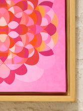 Load image into Gallery viewer, A close-up of a framed abstract floral canvas print featuring overlapping petal-like shapes in pink, coral, orange, and magenta tones, set in a light natural wood frame against a textured off-white wall.