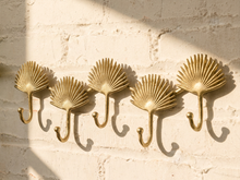 Load image into Gallery viewer, Vintage brass-tone wall hook rack with connected fan-shaped motifs and curved clothing hooks