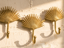 Load image into Gallery viewer, Vintage brass-tone wall hook rack with connected fan-shaped motifs and curved clothing hooks