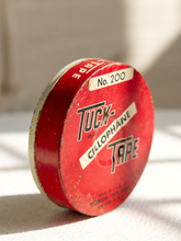 Load image into Gallery viewer, Vintage red Tuck Tape No. 200 cellophane tape round container with black and white advertising graphics