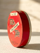 Load image into Gallery viewer, Vintage red Tuck Tape No. 200 cellophane tape round container with black and white advertising graphics