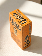 Load image into Gallery viewer, Vintage orange Oster hand clippers advertising box with illustrated portrait and John Oster Manufacturing Co. Racine Wisconsin branding