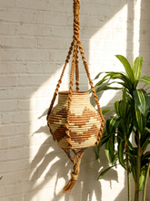 Load image into Gallery viewer, Vintage 1970s natural fiber macramé plant hanger with braided knots, twisted cord details, and tassel