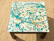 Load image into Gallery viewer, Vintage square side table with abstract green, orange, and yellow splatter-painted top and dark curved-leg base