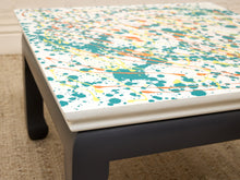 Load image into Gallery viewer, Vintage square side table with abstract green, orange, and yellow splatter-painted top and dark curved-leg base