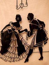 Load image into Gallery viewer, Black silhouette wall art depicting a dancing couple, mounted on a beige fabric backdrop with a hanging light fixture silhouette above.