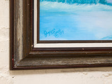 Load image into Gallery viewer, Close-up of a framed painting corner showing a blue and white seascape with a dark distressed wooden frame mounted on a textured off-white wall. A blue artist signature reading 'Jeffry Smith 87' is visible inside the frame.