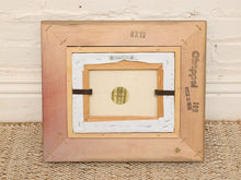 Load image into Gallery viewer, A vintage wooden picture frame shown from the back, featuring a light natural wood outer frame, a white paper backing, and a smaller inner wooden mount. The frame has '8x10' printed at the top and 'Chippel 109' printed on the right side, resting on a woven rug against a white brick wall.